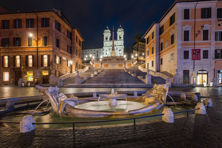 The city lights illuminate the Spanish Steps