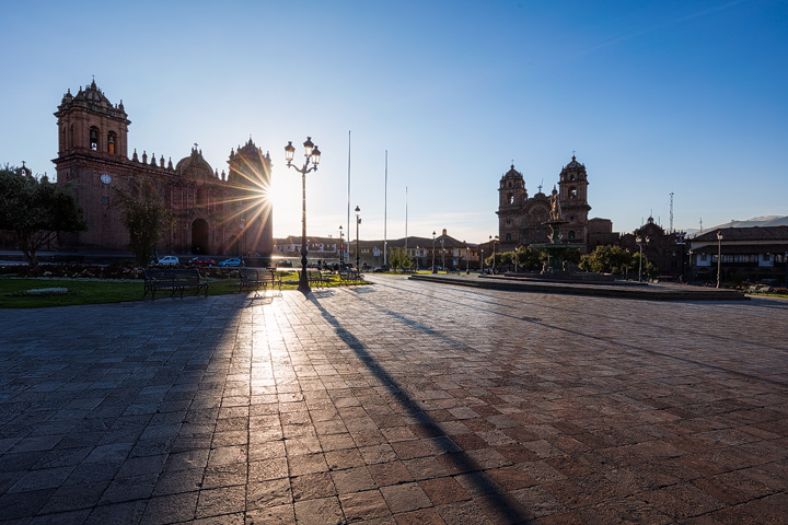 The sun rises behind the Cusco Cathedral