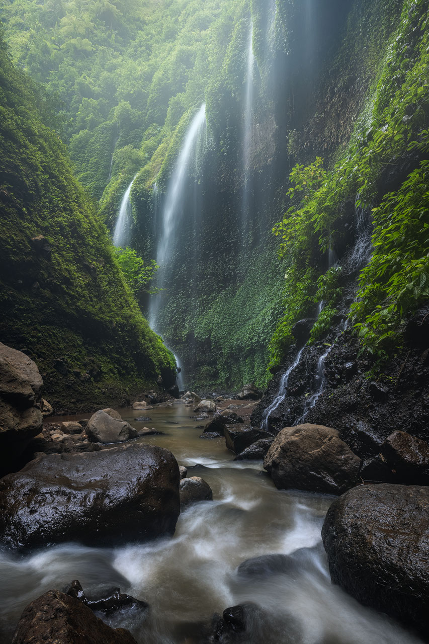 Madakaripura The green cliffs and cascades of the Madakaripura waterfall near Mount Bromo