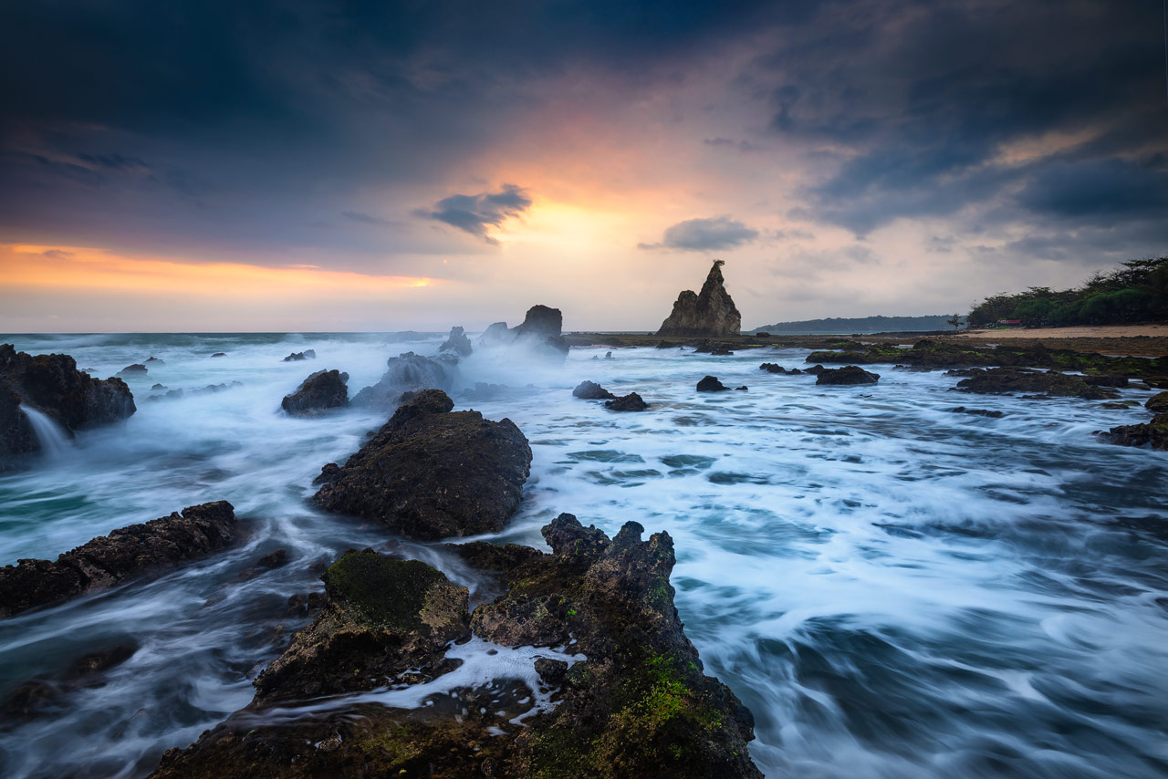 Waves crashing on the rocks at Tanjung Layar near Sawarna
