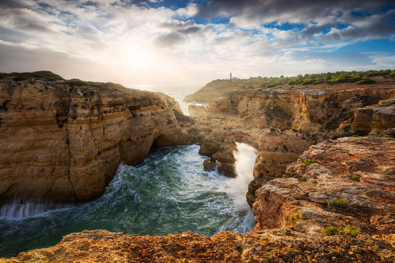Alfanzina Storm Enormous waves crashing on the rocks near Alfanzina Lighthouse at the Algarve