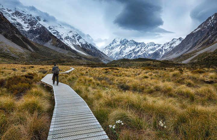 A person hiking through Hookder Valley with steep mountains in the distance