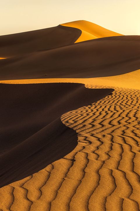 Lines in the Sand Golden light illuminates the dunes and structures of the Erg Chigaga