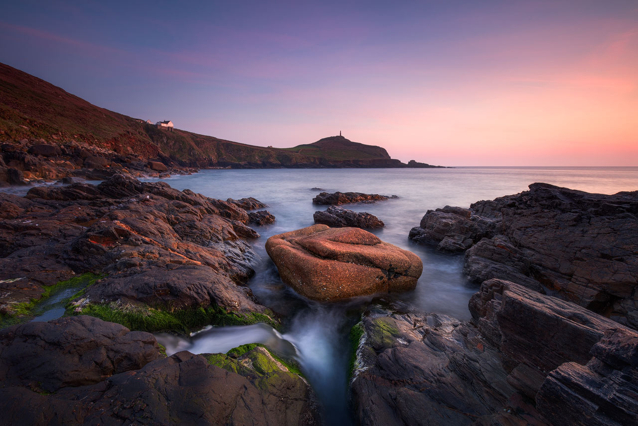 The rocky coast and cliffs at Porth Ledden in Cornwall during sunset.