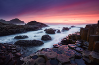 A dramatic sunset reflects on the hexagonal rocks of Giants Causeway in Antrim.