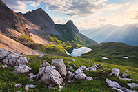 Rappensee Sunset Sunlight filters through the clouds to bath this mountain scene in ethereal light