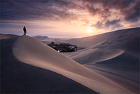 The high dunes around the town of Huacachina during a beautiful sunrise