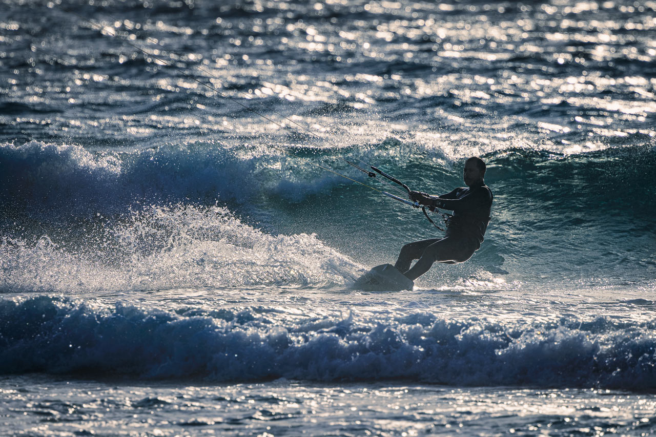 A Kite Surfer backlit by the sun at El Cotillo.