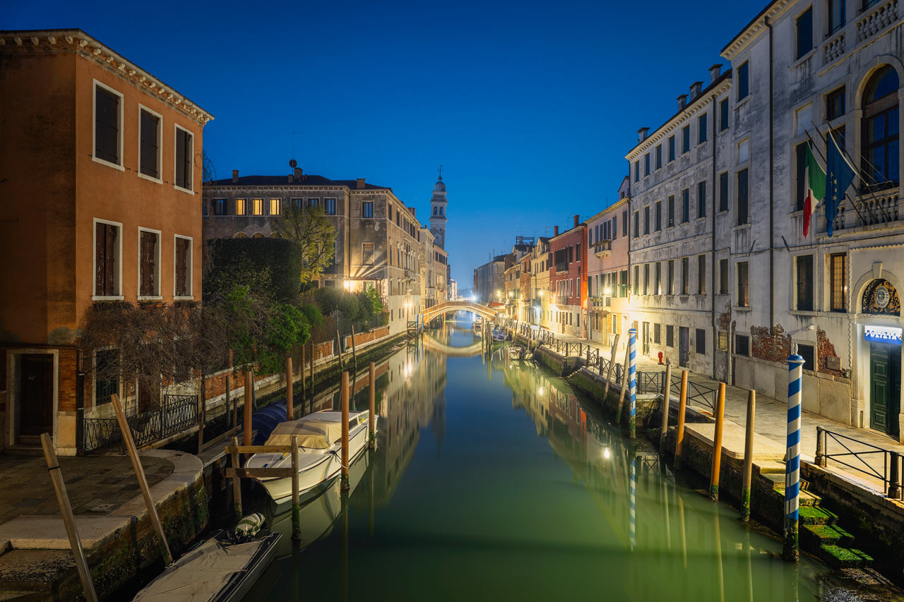 The facades of the picturesque buildings of Venice reflect in one of the many canals.
